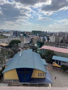 a building with a blue roof in a city at Olivia homes in Nairobi +17 photos