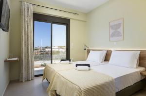 a bedroom with a large bed and a large window at Emmanouil Private Villa A in Roumelí +41 photos