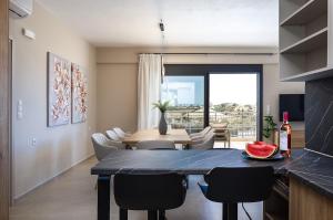 a kitchen and dining room with a table and chairs at Emmanouil Private Villa A in Roumelí