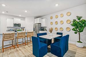 Una cocina y un comedor con una mesa y sillas azules. en Green Palm Beach Home Golf Cart Included, en Port Saint Joe