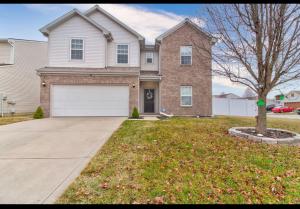 a brick house with a white garage at Camby in Indianapolis