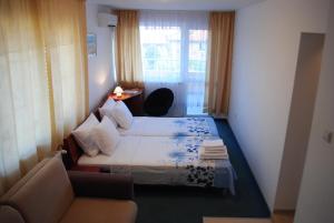 a hotel room with two beds and a couch at Veda Guest House in Pomorie +66 photos
