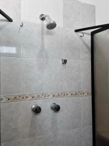 a shower with a glass door with a shower head at Casa Jalisco, Campeche 2 in Campeche