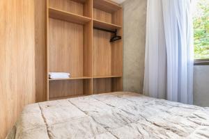 a bedroom with a bed and a window at Praça Cinco in Porto De Galinhas +59 photos
