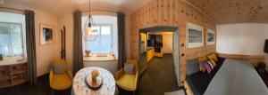 a living room with a table and yellow chairs at Útulný apartmán Vitkovice in Vítkovice