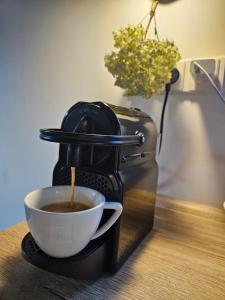 a coffee maker is making a cup of coffee at Chalupa pod Bínovem in Smržovka +32 photos