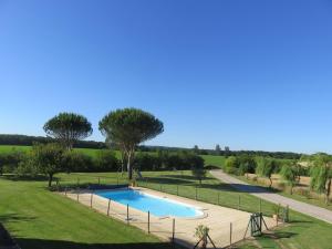 una piscina en un campo con una valla alrededor en Gîtes de La Carrétarié en Parisot