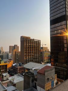 a view of a city skyline with tall buildings at High Rise Haven in Johannesburg +14 photos