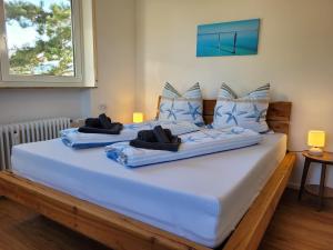 a bedroom with two beds with blue pillows at Ferienwohnung Ankerplatz Wangen in Öhningen +31 photos