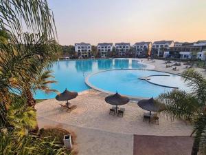 a large swimming pool with umbrellas in a resort at Blyde Lagoon in Pretoria