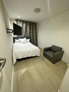 a bedroom with a bed and a chair at Joy House in Cape Town