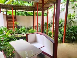 a white bench in a room with plants at Uva Blue Villas - Pool House - AC, 3 bedrooms, 7 guests, Indoor pool with spill in Cocles