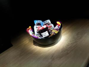 a bowl filled with candy on top of a wooden table at Charmant Studio Climatisé plein centre d'Aubagne in Aubagne