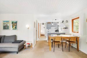 a living room and kitchen with a table and a couch at 4705-Aakirkeby-Sondre-Landevej-60 in Åkirkeby