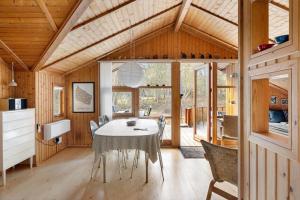 a dining room with a table and chairs at 2544-Nexo-Skovsangervej-29 in Neksø