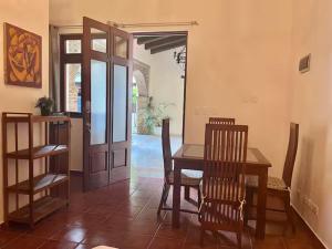 a dining room with a table and chairs and a door at Paseo Colonial - El Monasterio #4 in Santo Domingo