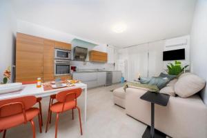 a kitchen and living room with a couch and a table at Mirella's cute place Udine in Udine
