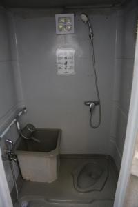 a small bathroom with a shower and a toilet at Iglam Ijen in Biau