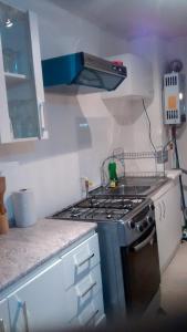 a kitchen with a stove and a counter top at Departamentos Rohe in Puerto Montt