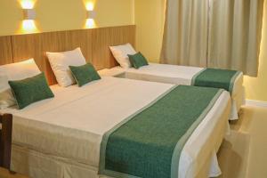 Ένα ή περισσότερα κρεβάτια σε δωμάτιο στο Maren Praia Hotel
