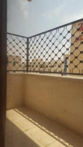 a bathroom with a wall with tiles on it at Tareq Residence in Amman