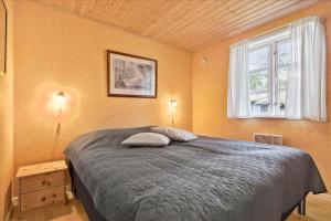 a bedroom with a bed with two pillows on it at 3517-Nexo-Turistvej-47-B in Neksø