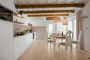 a kitchen and dining room with a table and chairs at Piccola Grande Casa in Mátraterenye