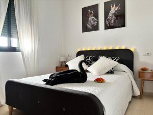 a bedroom with a bed with a swan on it at Casa Azacanes in Sanlúcar de Barrameda