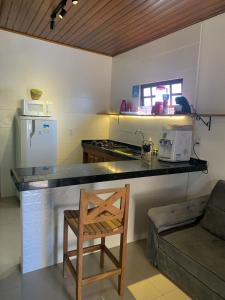 a kitchen with a counter and a chair in a room at 07 Apartamento com vista para a montanha in São Sebastião +12 photos