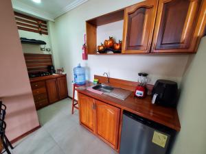 a kitchen with a sink and a counter top at Beautiful view suite Suite vista hermosa in Macas +39 photos
