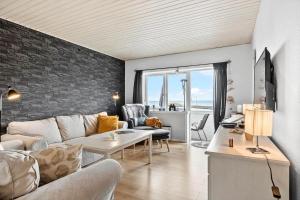 a living room with a couch and a table at 5598-Allinge-Ndr-Strandvej-4-A-1-th in Allinge
