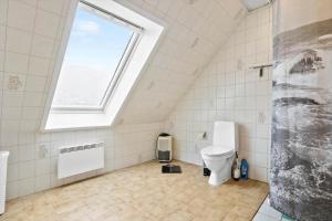 a bathroom with a toilet and a window at 5598-Allinge-Ndr-Strandvej-4-A-1-th in Allinge +13 photos