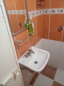 a bathroom with a white sink and a mirror at Casa rural GuerrApa in San Agustín