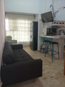 a living room with a black couch and a table at Casa rural GuerrApa 