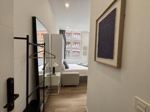 a hallway with a room with a bed and a mirror at Gabika Apartment 2 in Bilbao
