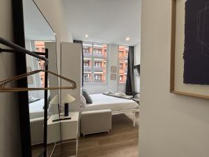 a small room with a bed and a window at Gabika Apartment 2 in Bilbao +19 photos