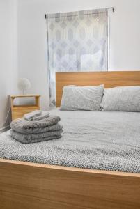 a bedroom with a bed with a wooden head board at Avenir Centre Suite - Near NBCC - Large Garden in Moncton
