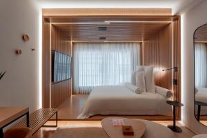 a bedroom with a bed and a large window at v3rso Jardins in Sao Paulo +42 photos