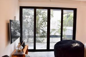 a living room with a large glass window at Exclusivo 3 Hab, Terraza Privada, Alberca y Asador in Tulum