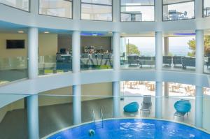 a large building with a pool in the middle of it at Sentido Thassos Imperial in Skala Rachoniou