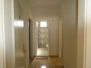 a hallway with a door leading to a bathroom at Apartments In Amor in Ulcinj +48 photos