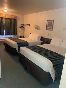 a hotel room with two beds and a window at Rails Inn in Forsyth