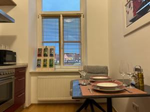 a kitchen with a table with plates and wine glasses at Isartor Rooms - SHARED BATHROOM in Munich