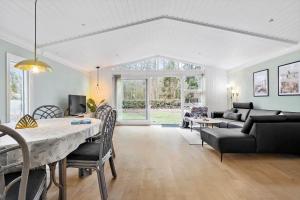 a living room with a table and a couch at 4759-Ronne-Stampen-Vej-1-Hus-4 in Rønne