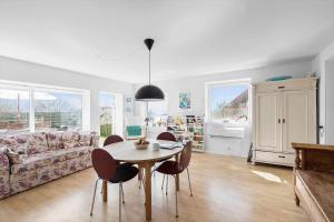 a living room with a table and chairs and a couch at 4728-Ronne-Brobakken-16 in Rønne