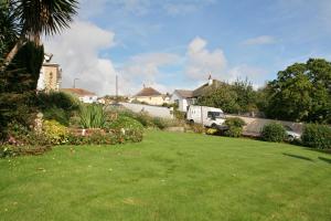 a yard with a green lawn in a house at Churston Way Lodge Guest House in Brixham