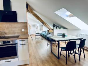 a kitchen and living room with a table and chairs at The Art Nest in Kutná Hora