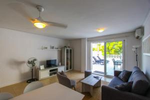 a living room with a couch and a table at Wake up by the sea in your cozy Denia corner in Denia