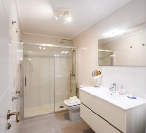 a bathroom with a shower and a toilet and a sink at Wake up by the sea in your cozy Denia corner in Denia +33 photos