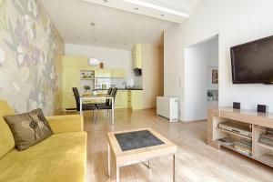 a living room with a couch and a dining room at Central Krak Apartments in Krakow